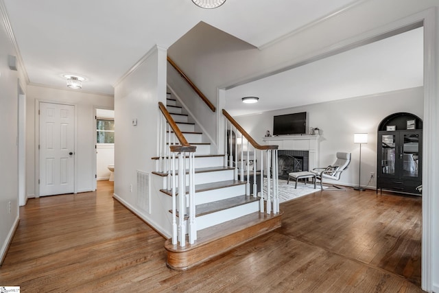119 Circle Slope Dr, Simpsonville, SC 29681 - foyer with stairway, wood finished floors, a brick fireplace, crown molding, and baseboards