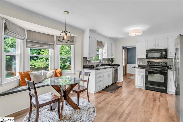 16 Chariot Ln, Simpsonville, SC 29681 - kitchen with black appliances, dark countertops, tasteful backsplash, white cabinetry, and a sink