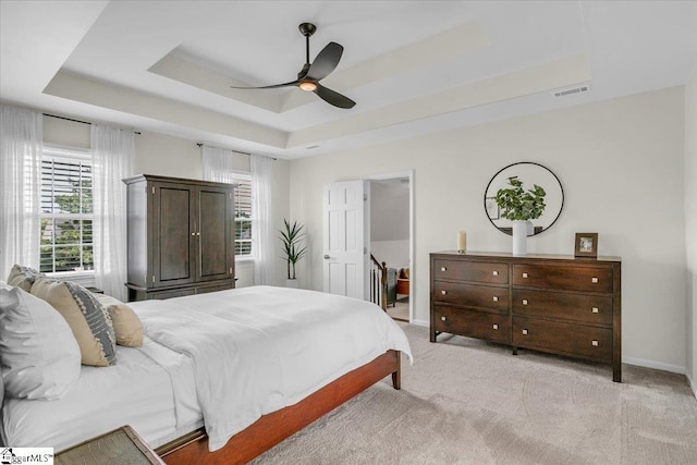 16 Chariot Ln, Simpsonville, SC 29681 - bedroom featuring a tray ceiling, light carpet, baseboards, and a ceiling fan