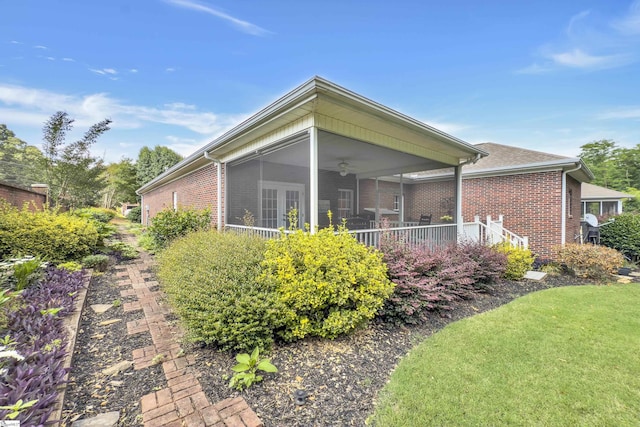 17 Bradford N Way, Greenville, SC 29617 - rear view of house with brick siding, a ceiling fan, a sunroom, and a lawn