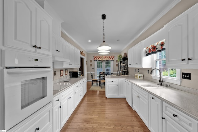 17 Bradford N Way, Greenville, SC 29617 - kitchen featuring white oven, a sink, crown molding, white cabinetry, and light wood-type flooring