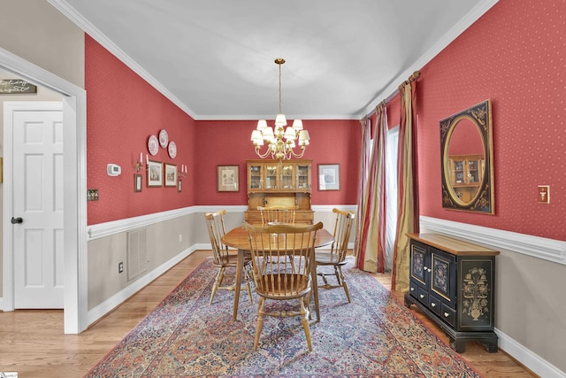 17 Bradford N Way, Greenville, SC 29617 - dining space with a chandelier, wood finished floors, crown molding, and wallpapered walls