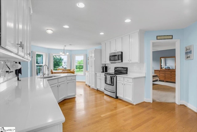 30 Chalice Hill Ln, Travelers Rest, SC 29690 - kitchen with appliances with stainless steel finishes, a sink, a peninsula, white cabinetry, and recessed lighting