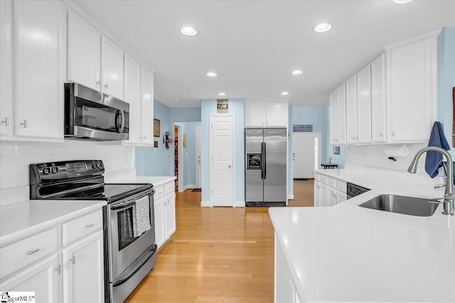 30 Chalice Hill Ln, Travelers Rest, SC 29690 - kitchen with appliances with stainless steel finishes, a sink, recessed lighting, backsplash, and light wood-type flooring