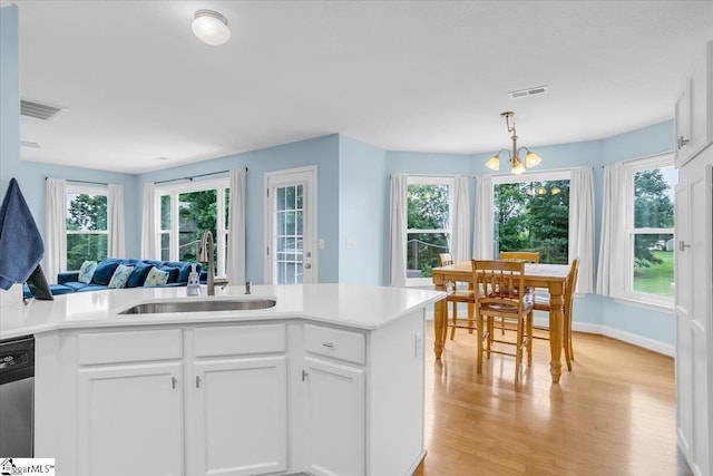 30 Chalice Hill Ln, Travelers Rest, SC 29690 - kitchen featuring a sink, light wood finished floors, white cabinets, a chandelier, and light countertops
