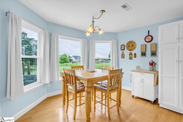 30 Chalice Hill Ln, Travelers Rest, SC 29690 - dining room with light wood-style flooring, a chandelier, baseboards, and plenty of natural light