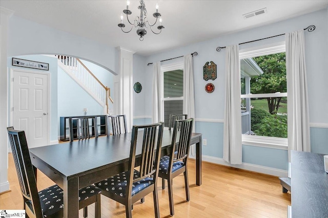 30 Chalice Hill Ln, Travelers Rest, SC 29690 - dining room featuring light wood-style flooring, a chandelier, baseboards, arched walkways, and stairway