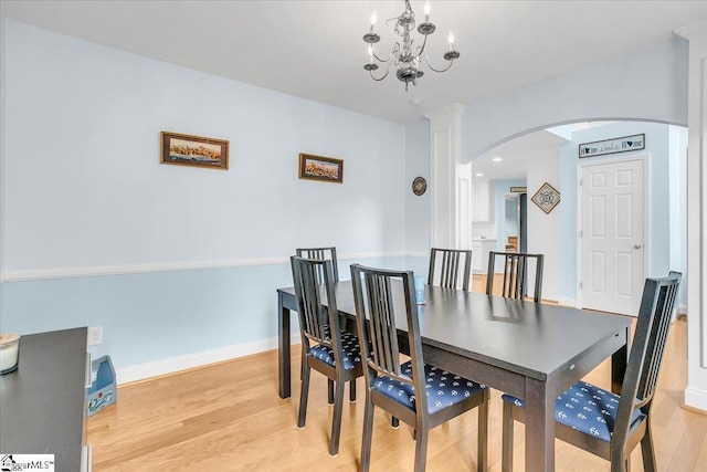 30 Chalice Hill Ln, Travelers Rest, SC 29690 - dining room featuring arched walkways, light wood-type flooring, a chandelier, and baseboards