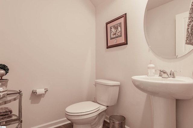 304 Oakmont Valley Trl, Seneca, SC 29678 - half bathroom featuring toilet, baseboards, a sink, and wood finished floors
