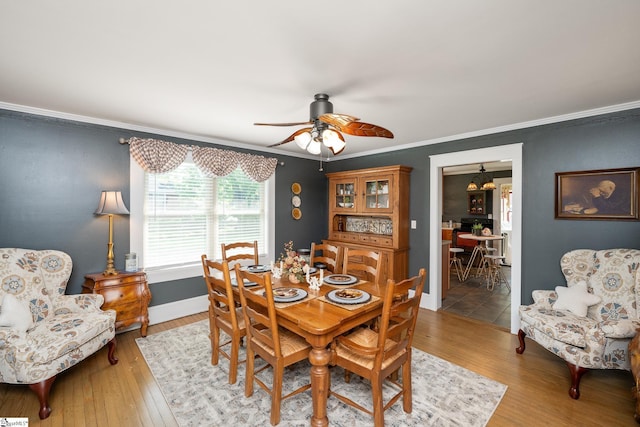201 W Highland Ave, Anderson, SC 29625 - dining space featuring crown molding, a ceiling fan, light wood-style flooring, and baseboards