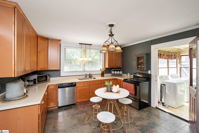 201 W Highland Ave, Anderson, SC 29625 - kitchen featuring appliances with stainless steel finishes, washer and clothes dryer, a sink, stone finish floors, and light countertops