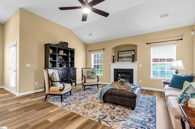 101 Peaks Ct, Taylors, SC 29687 - living room with wood finished floors, plenty of natural light, ceiling fan, a glass covered fireplace, and vaulted ceiling