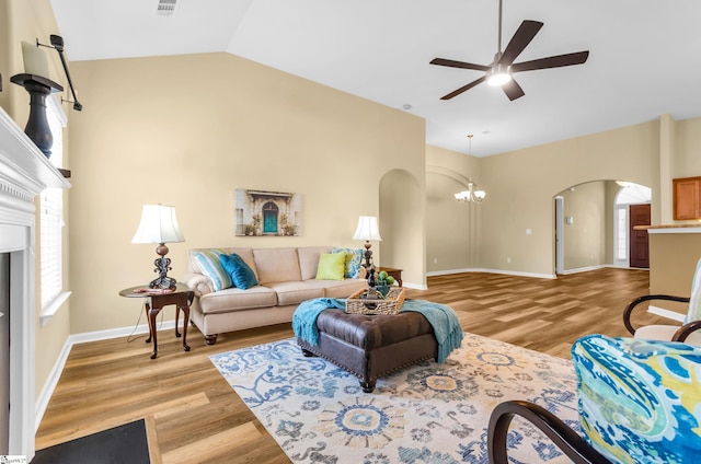 101 Peaks Ct, Taylors, SC 29687 - living area featuring arched walkways, ceiling fan, a fireplace, light wood-style flooring, and vaulted ceiling