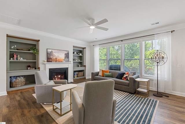 712 Paxton Rose Dr, Greer, SC 29650 - living area with a glass covered fireplace, ornamental molding, ceiling fan, built in shelves, and baseboards