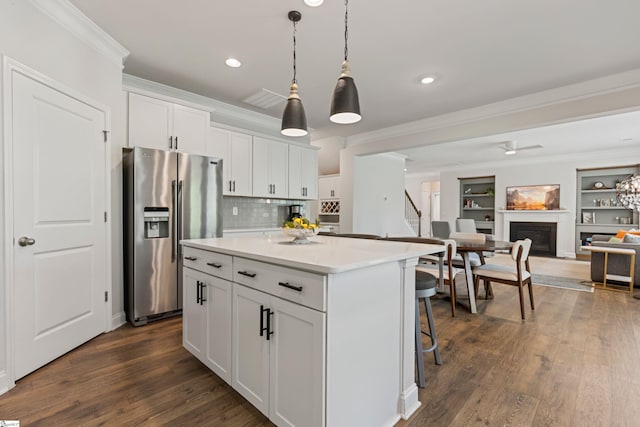 712 Paxton Rose Dr, Greer, SC 29650 - kitchen featuring stainless steel fridge, crown molding, a kitchen island, white cabinets, and open floor plan