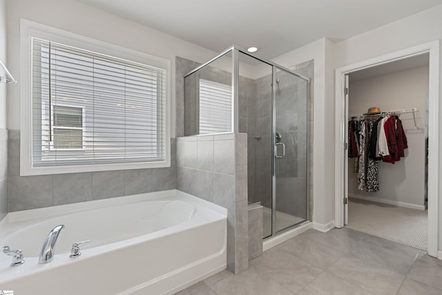 712 Paxton Rose Dr, Greer, SC 29650 - full bathroom featuring a bath, a shower stall, a spacious closet, baseboards, and tile patterned flooring