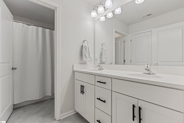 712 Paxton Rose Dr, Greer, SC 29650 - full bath with double vanity, tile patterned flooring, baseboards, and a shower with shower curtain