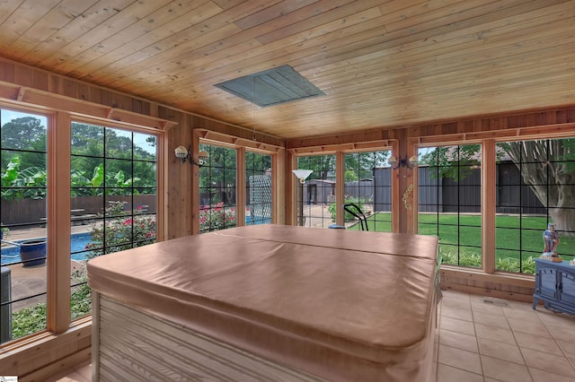 101 Myrtle St, Lavonia, GA 30553 - sunroom with a hot tub, wood ceiling, tile patterned floors, wood walls, and plenty of natural light