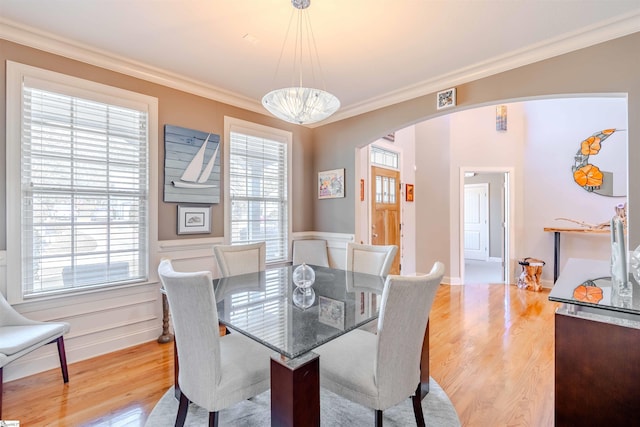 9 Windswept Knoll Dr, Taylors, SC 29687 - dining area featuring arched walkways, ornamental molding, light wood-style flooring, and wainscoting