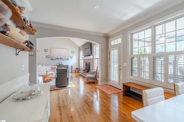 9 Windswept Knoll Dr, Taylors, SC 29687 - living area with a stone fireplace, ornamental molding, wood finished floors, arched walkways, and lofted ceiling