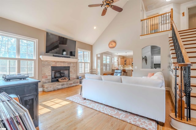 9 Windswept Knoll Dr, Taylors, SC 29687 - living room with a ceiling fan, a stone fireplace, wood finished floors, plenty of natural light, and high vaulted ceiling