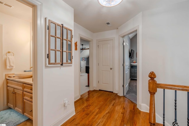 9 Windswept Knoll Dr, Taylors, SC 29687 - hall featuring light wood finished floors, a sink, baseboards, and an upstairs landing