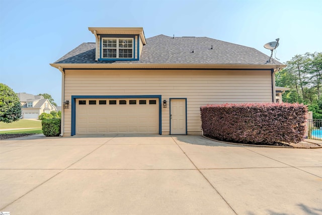 9 Windswept Knoll Dr, Taylors, SC 29687 - view of side of property featuring concrete driveway, a shingled roof, and a garage