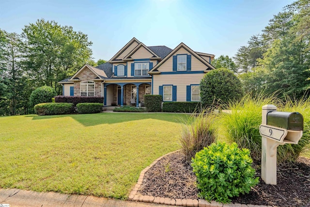 9 Windswept Knoll Dr, Taylors, SC 29687 - craftsman inspired home featuring covered porch, a front lawn, and stone siding