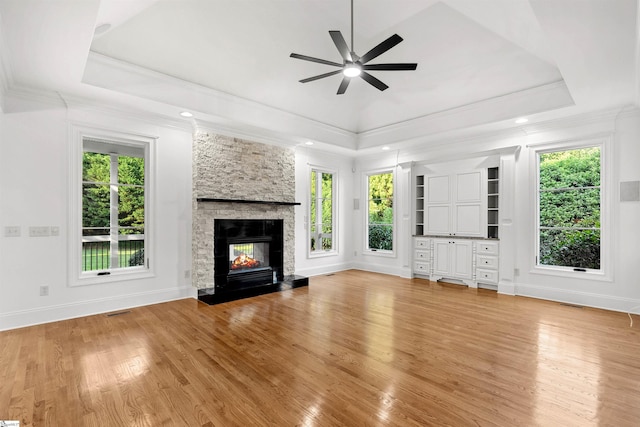 601 Brixton Cir, Simpsonville, SC 29681 - unfurnished living room featuring ceiling fan, healthy amount of natural light, a tray ceiling, light wood-type flooring, and ornamental molding