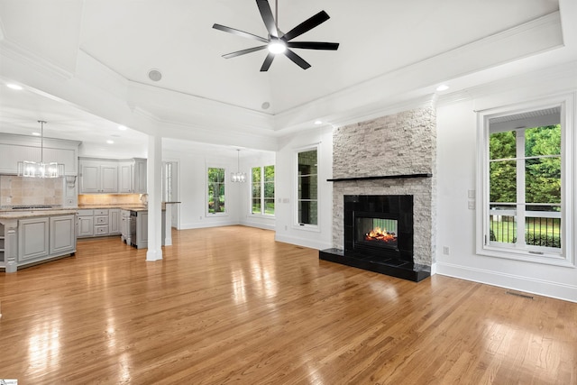 601 Brixton Cir, Simpsonville, SC 29681 - unfurnished living room featuring a ceiling fan, light wood-type flooring, ornamental molding, a fireplace, and baseboards