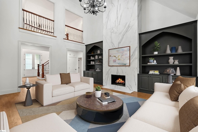 601 Brixton Cir, Simpsonville, SC 29681 - living room with built in features, baseboards, wood finished floors, a fireplace, and a chandelier