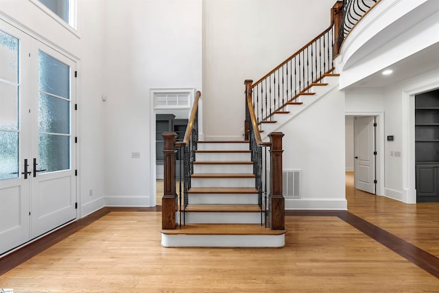 601 Brixton Cir, Simpsonville, SC 29681 - entrance foyer with wood finished floors, stairway, a high ceiling, baseboards, and plenty of natural light