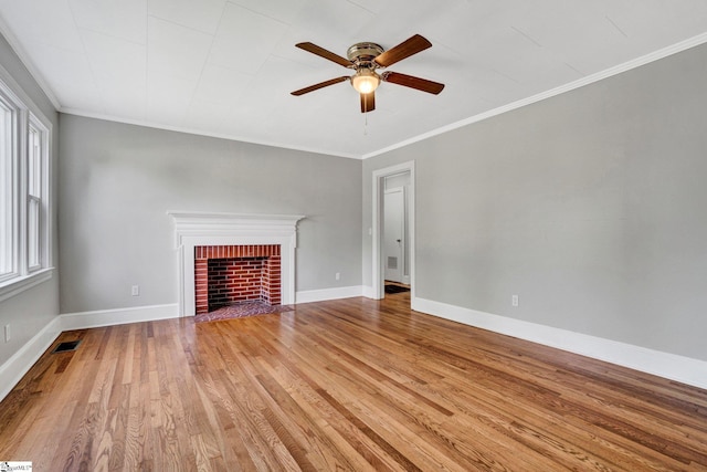 503 Davidson St, Clinton, SC 29325 - unfurnished living room with ceiling fan, light wood-style flooring, ornamental molding, a brick fireplace, and baseboards