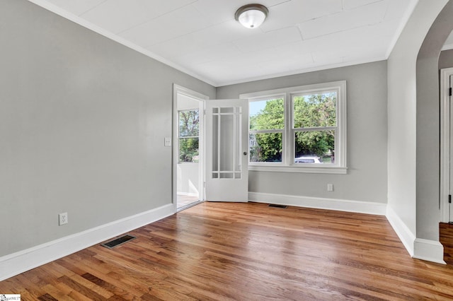 503 Davidson St, Clinton, SC 29325 - empty room with arched walkways, ornamental molding, baseboards, and wood finished floors