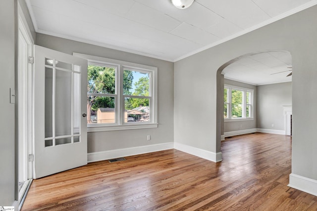 503 Davidson St, Clinton, SC 29325 - unfurnished room featuring arched walkways, crown molding, wood finished floors, baseboards, and a ceiling fan