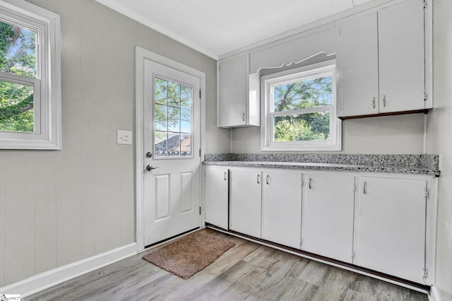 503 Davidson St, Clinton, SC 29325 - kitchen featuring light wood-style floors, white cabinets, ornamental molding, and light stone countertops