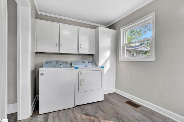 503 Davidson St, Clinton, SC 29325 - laundry room with cabinet space, washer and dryer, wood finished floors, ornamental molding, and baseboards