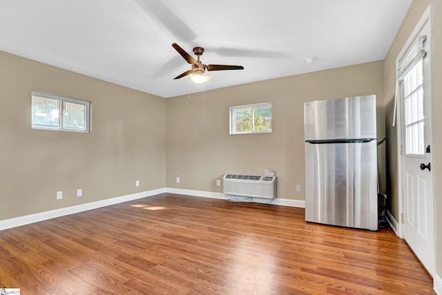 503 Davidson St, Clinton, SC 29325 - unfurnished room with a ceiling fan, light wood-style flooring, baseboards, a smoke detector, and a wall mounted air conditioner