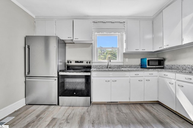 503 Davidson St, Clinton, SC 29325 - kitchen featuring stainless steel appliances, a sink, light wood-style flooring, white cabinets, and ornamental molding