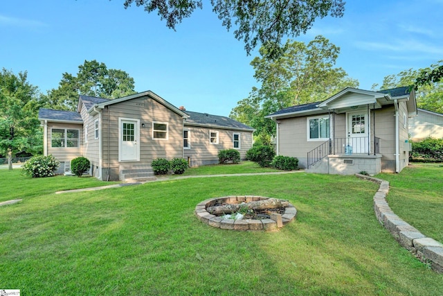 503 Davidson St, Clinton, SC 29325 - back of house featuring a lawn and an outdoor fire pit