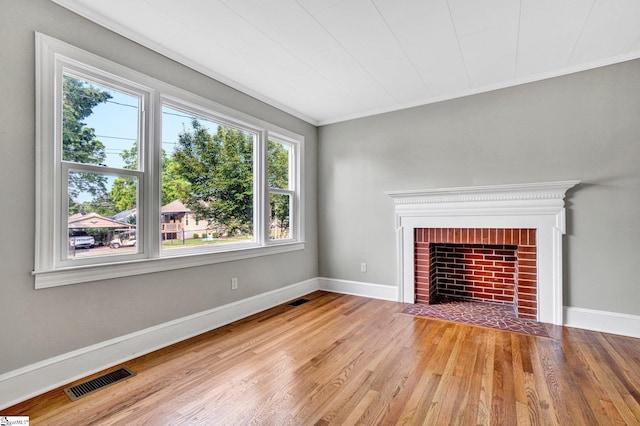 503 Davidson St, Clinton, SC 29325 - unfurnished living room featuring wood finished floors, baseboards, a brick fireplace, and crown molding
