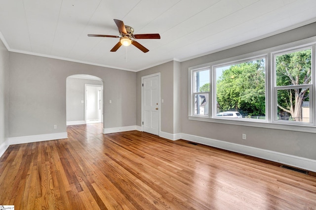 503 Davidson St, Clinton, SC 29325 - spare room with arched walkways, a ceiling fan, light wood-style floors, ornamental molding, and baseboards