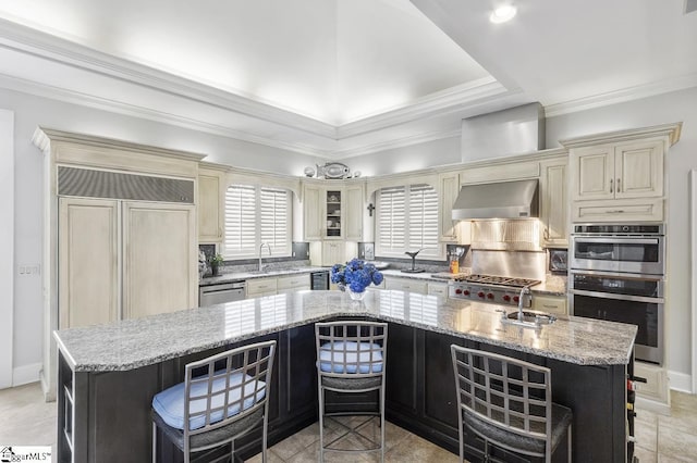 33 Southview Ledge Rd, Landrum, SC 29356 - kitchen featuring cream cabinets, wall chimney exhaust hood, a sink, a kitchen island, and a kitchen breakfast bar