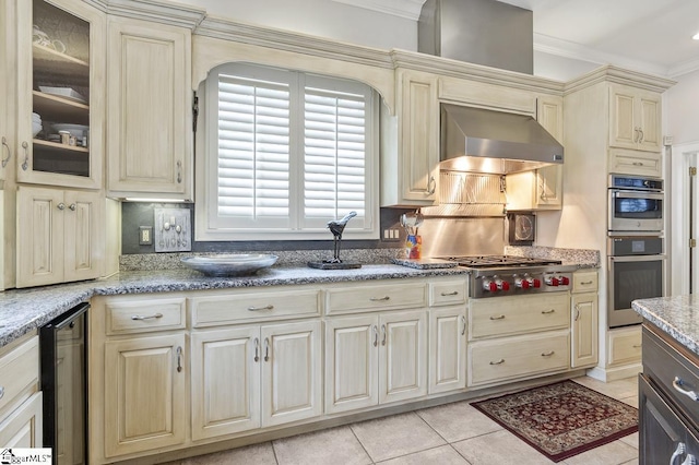 33 Southview Ledge Rd, Landrum, SC 29356 - kitchen with cream cabinets, wall chimney range hood, crown molding, stainless steel appliances, and light tile patterned floors