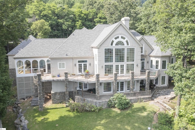 33 Southview Ledge Rd, Landrum, SC 29356 - rear view of property featuring stucco siding, a chimney, a lawn, stone siding, and roof with shingles