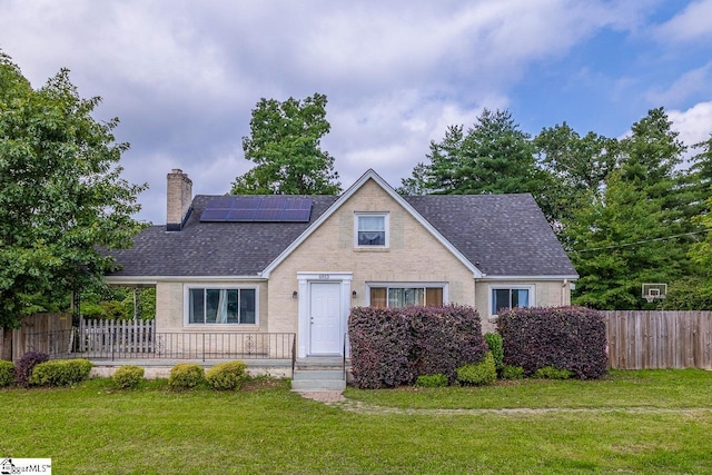 6913 White Horse Rd, Greenville, SC 29611 - view of front facade with roof mounted solar panels, a chimney, roof with shingles, and brick siding