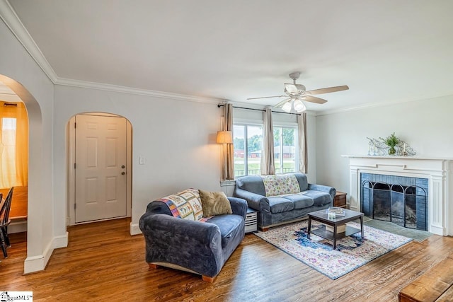 6913 White Horse Rd, Greenville, SC 29611 - living room featuring wood finished floors, arched walkways, ceiling fan, ornamental molding, and a fireplace