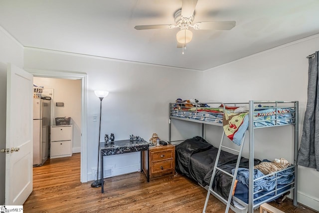 6913 White Horse Rd, Greenville, SC 29611 - bedroom featuring wood finished floors, freestanding refrigerator, a ceiling fan, and crown molding