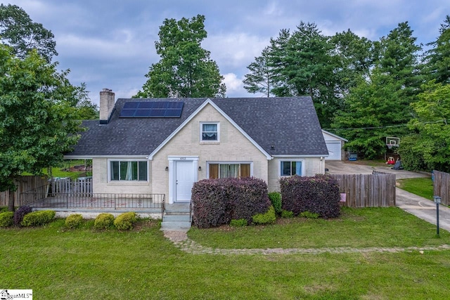 6913 White Horse Rd, Greenville, SC 29611 - view of front of property featuring a chimney, roof mounted solar panels, and roof with shingles