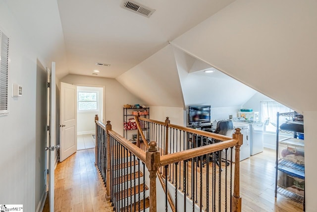 6913 White Horse Rd, Greenville, SC 29611 - corridor with an upstairs landing, vaulted ceiling, light wood-style flooring, and baseboards